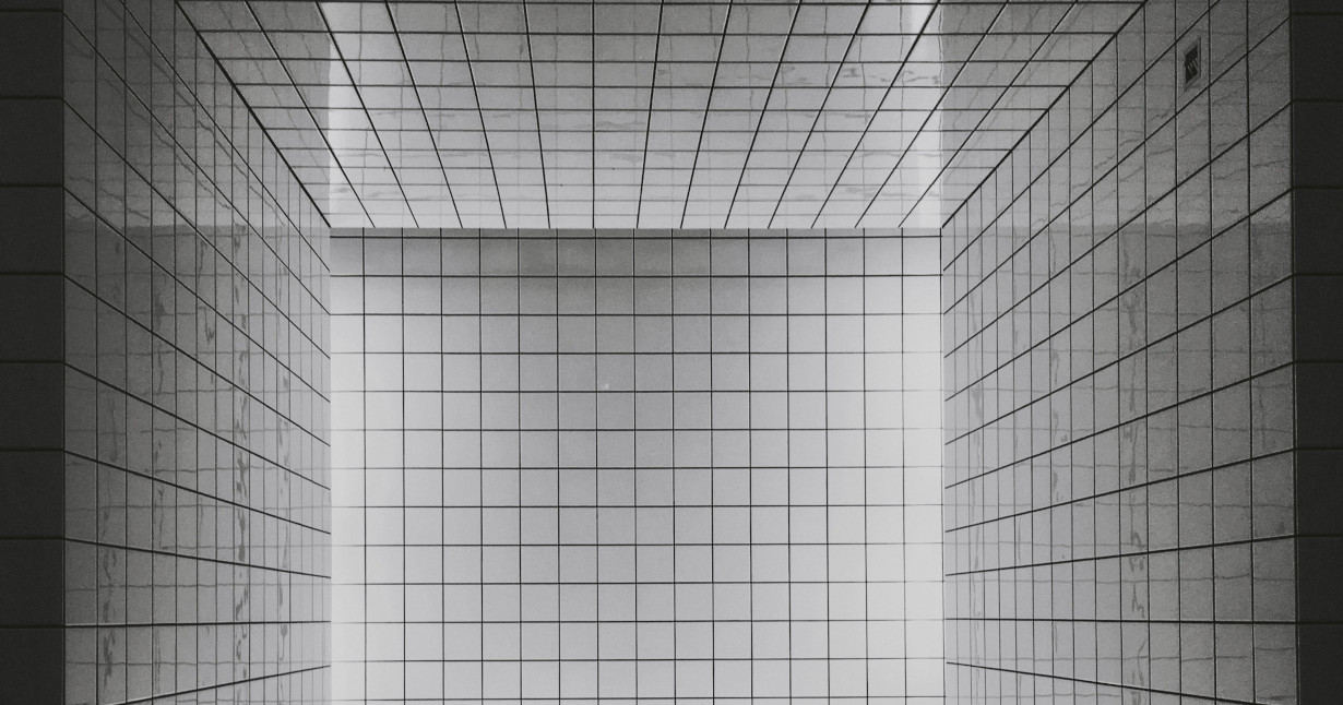 confusing grid of white square tiles with black seams